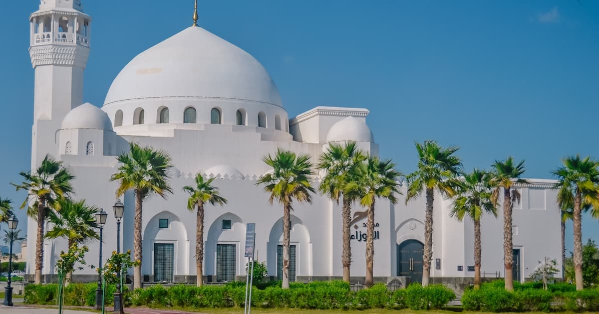 Ecommerce business setup in Saudi Arabia with laptop and Saudi cityscape